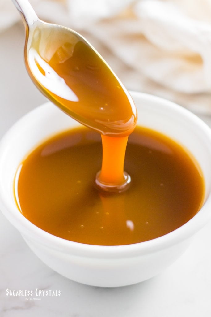 Keto caramel sauce in bowl with spoon