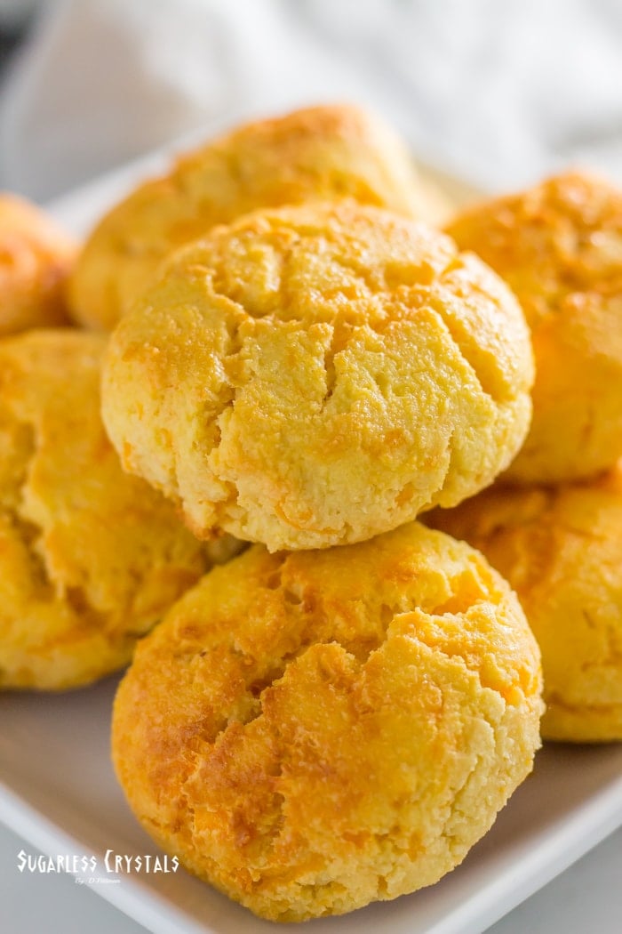 keto cheddar biscuits on plate in a pile