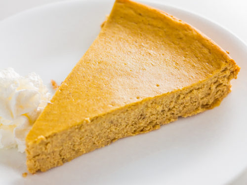 Pumpkin spice keto cheesecake on a plate sliced