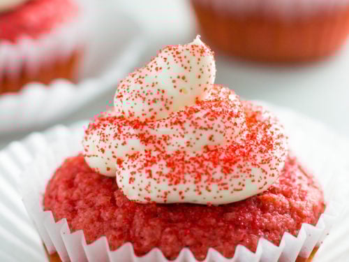 Keto red velvet cupcakes with cream cheese frosting and sprinkles