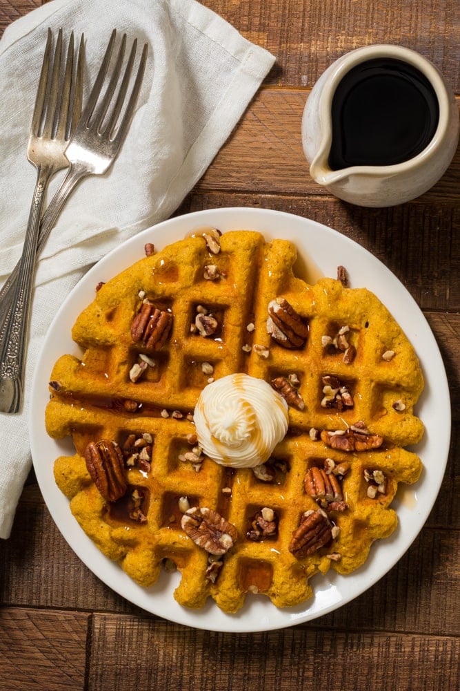 keto pumpkin waffles with whipped cream and pecans