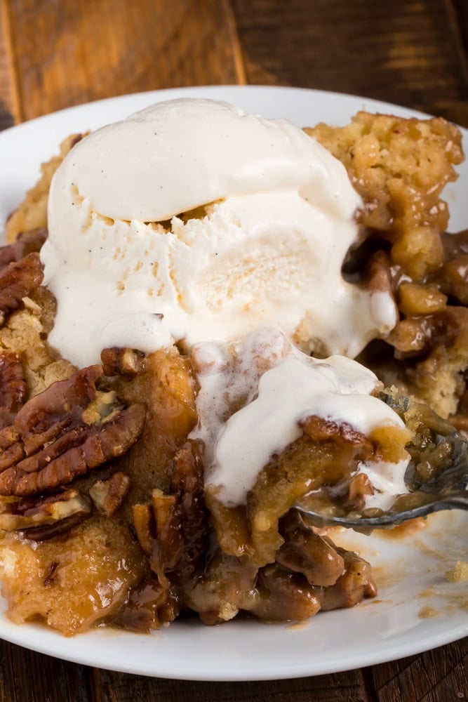 pecan pie cobbler served with ice cream being eating