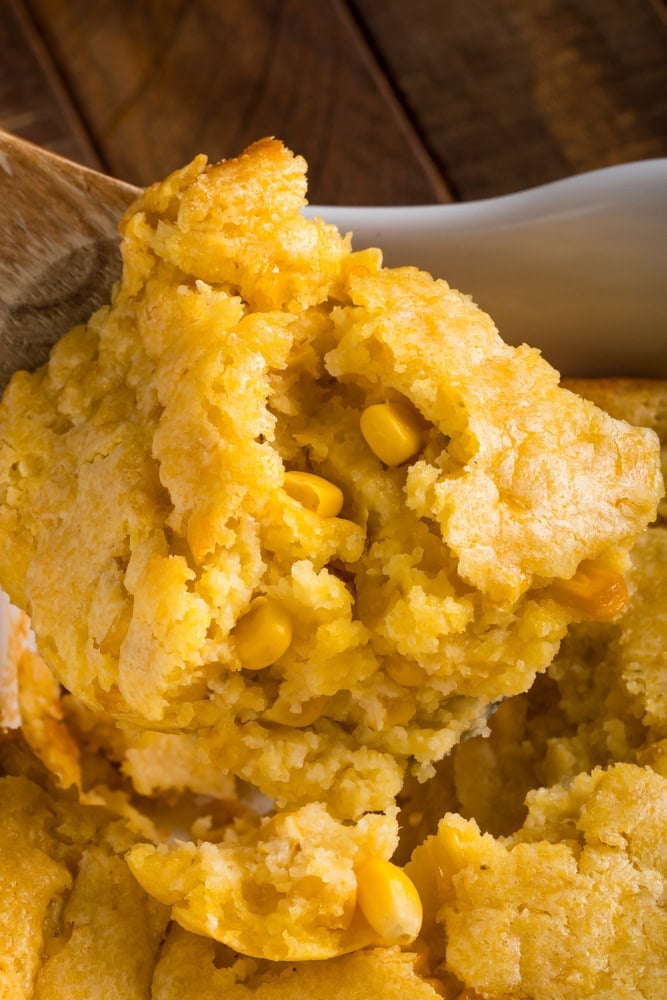 corn soufflé being scooped from the serving dish close-up