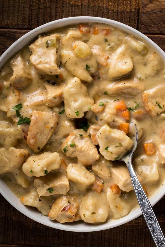 chicken and dumplings with canned biscuits served in bowl with spoon