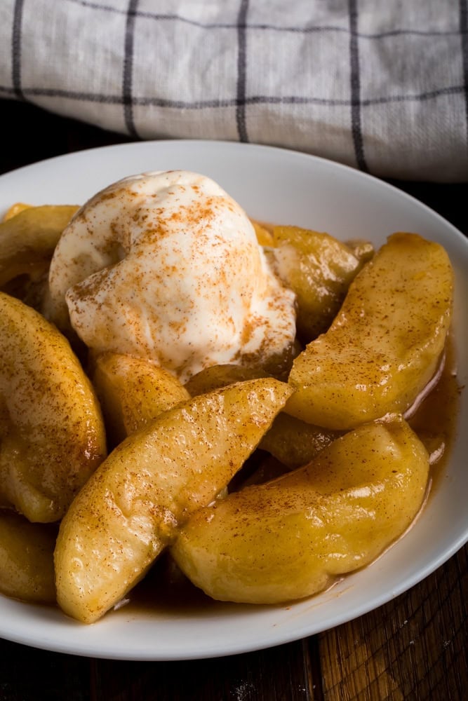 Fried apples topped with vanilla ice cream and cinnamon