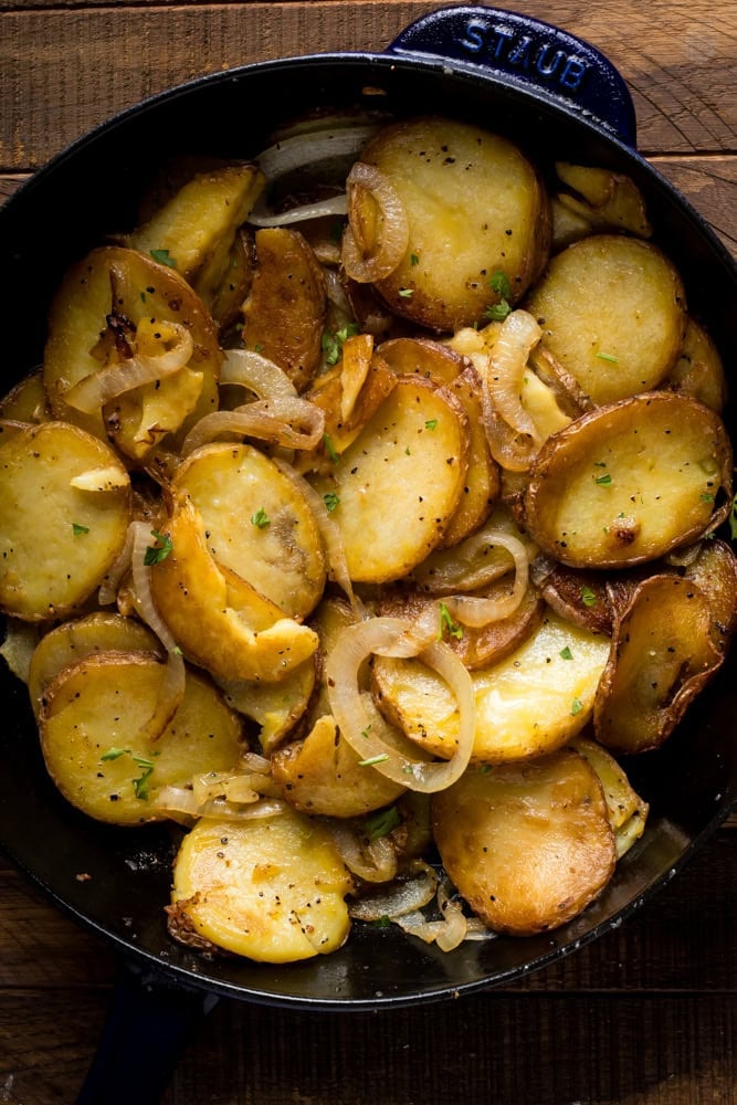 fried potatoes and onion in cast iron skillet