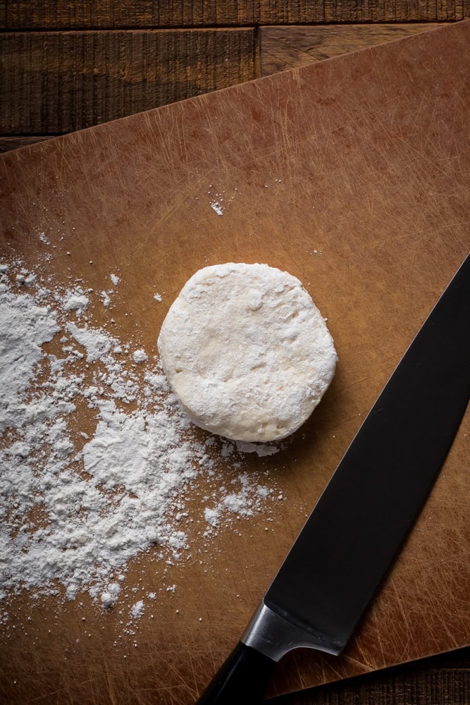 canned biscuits coated in flour before cutting for chicken and dumplings