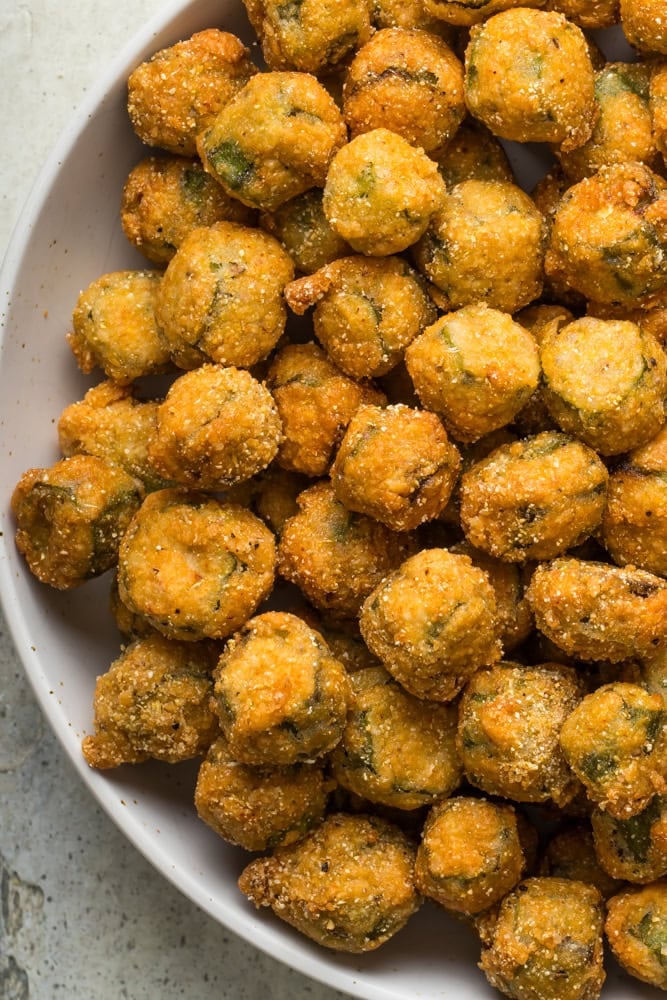 Golden brown Southern fried okra with a crisp cornmeal coating in a serving bowl.