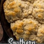 Pinterest pin for Southern Cathead Biscuits showing large rustic biscuits baked until golden in a cast iron skillet.