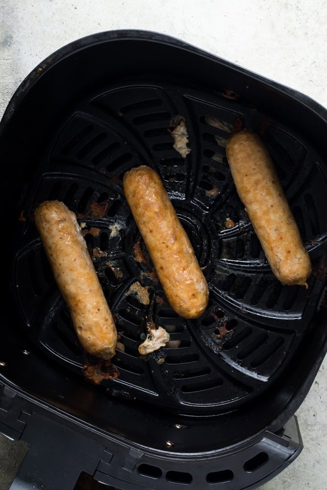 Raw chicken sausage cooked in the air fryer until browned and fully cooked through.