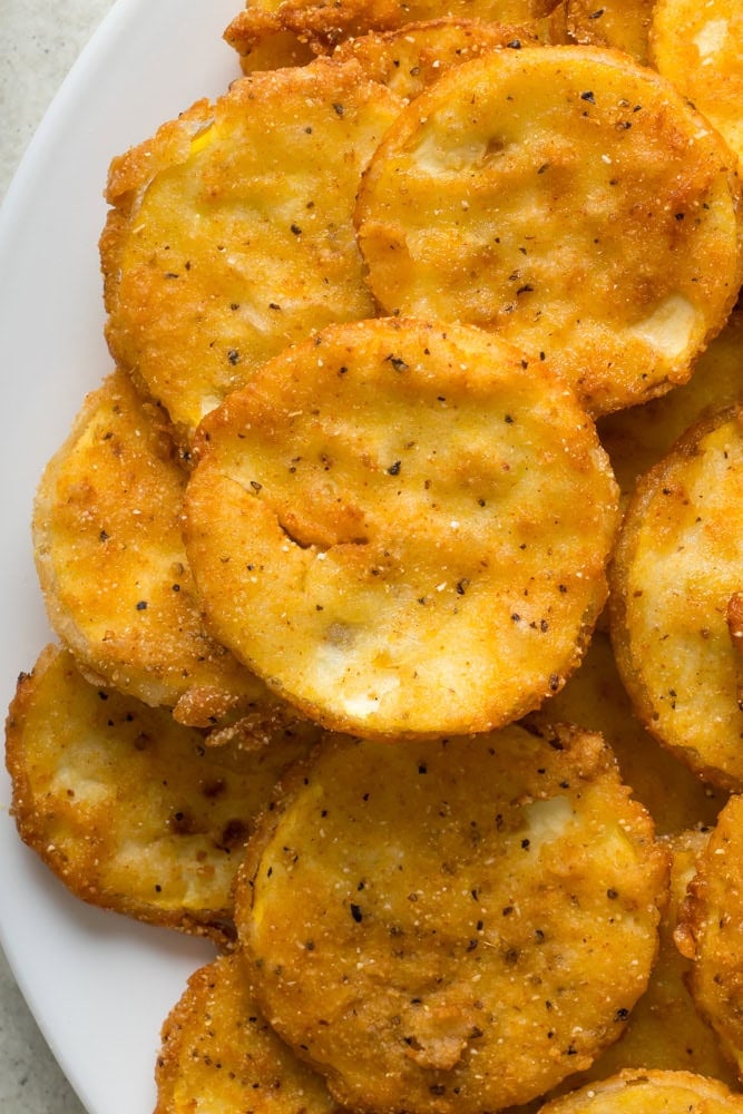 Crispy Southern fried squash slices showing the golden breading and tender yellow squash centers.